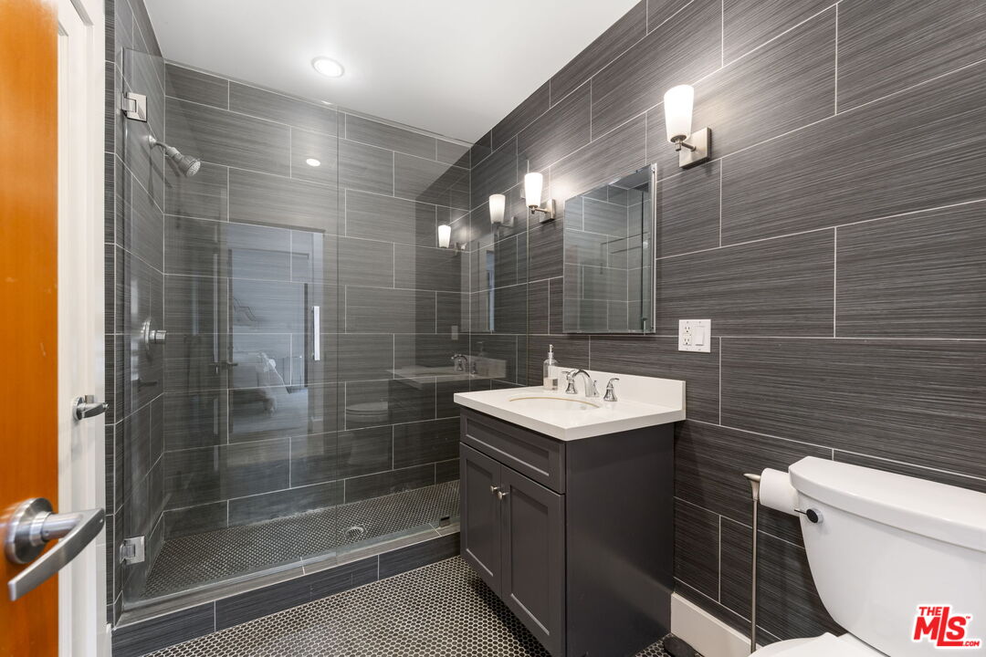 2601 Nichols Canyon Road Los Angeles, CA 90046 - Photo 15 of 28 a bathroom with a sink a toilet and shower