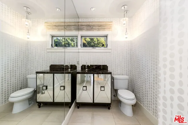 a view of a chair and table in backyard of the house