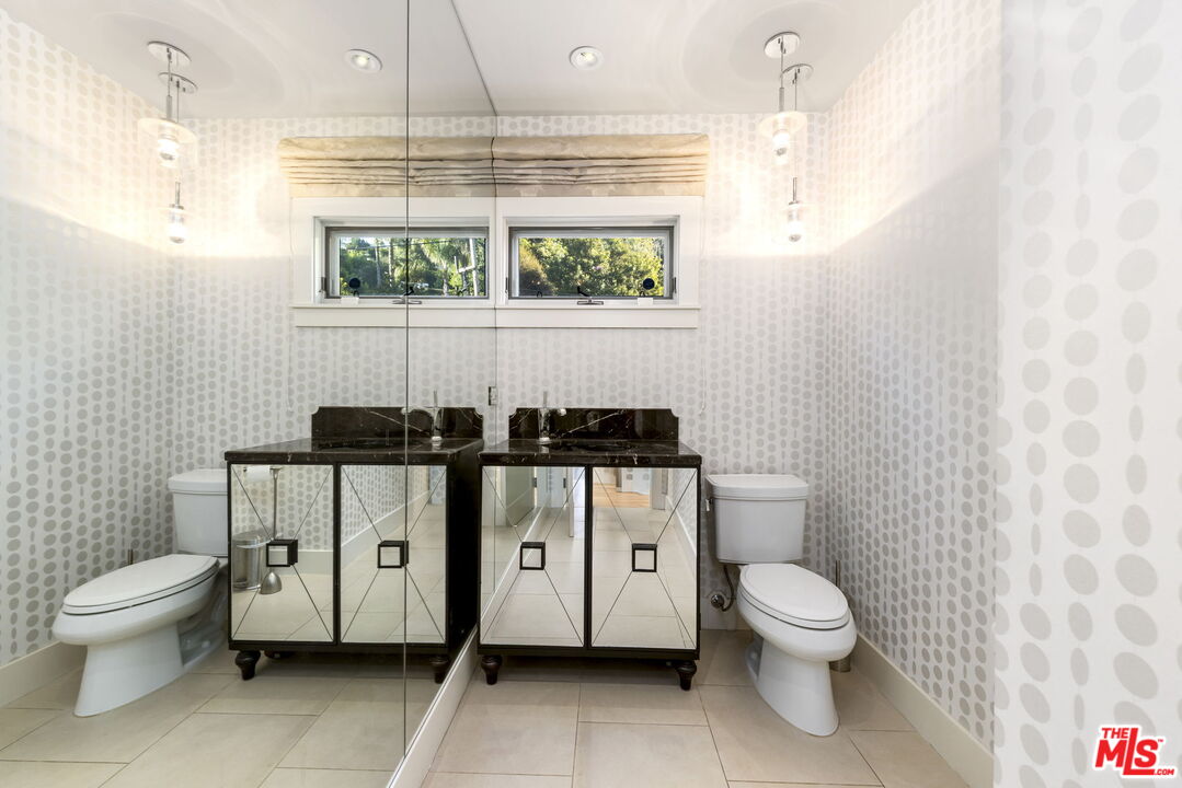 2601 Nichols Canyon Road Los Angeles, CA 90046 - Photo 17 of 28 a bathroom with a toilet sink and mirror