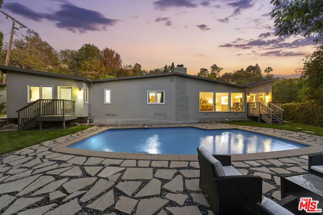 a view of a backyard with swimming pool