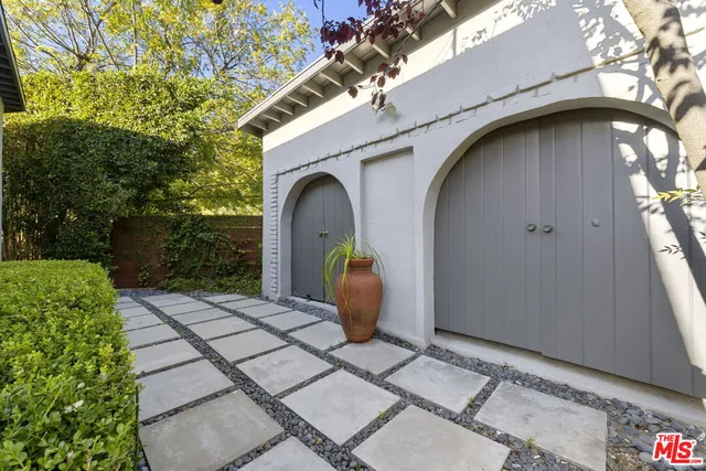 an aerial view of a house with a yard swimming pool and patio