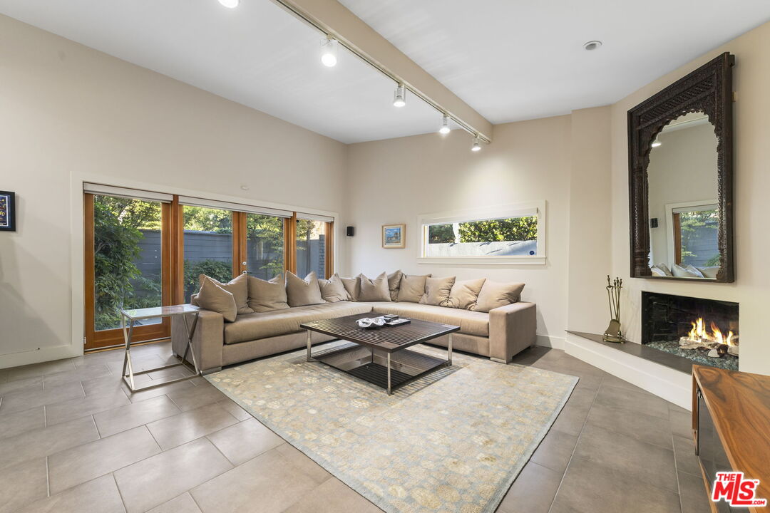 2601 Nichols Canyon Road Los Angeles, CA 90046 - Photo 4 of 28 a living room with furniture large window and a fireplace