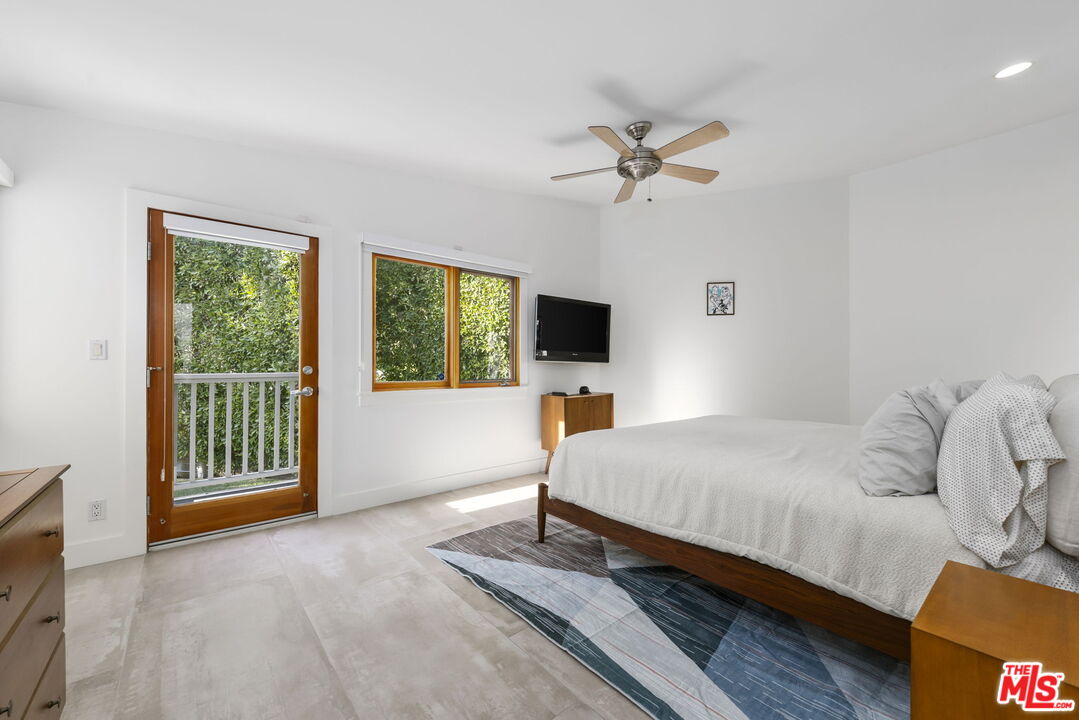 2601 Nichols Canyon Road Los Angeles, CA 90046 - Photo 9 of 28 a spacious bedroom with a bed and a flat screen tv