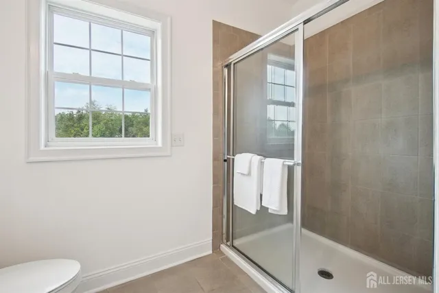 a bathroom with a shower and toilet