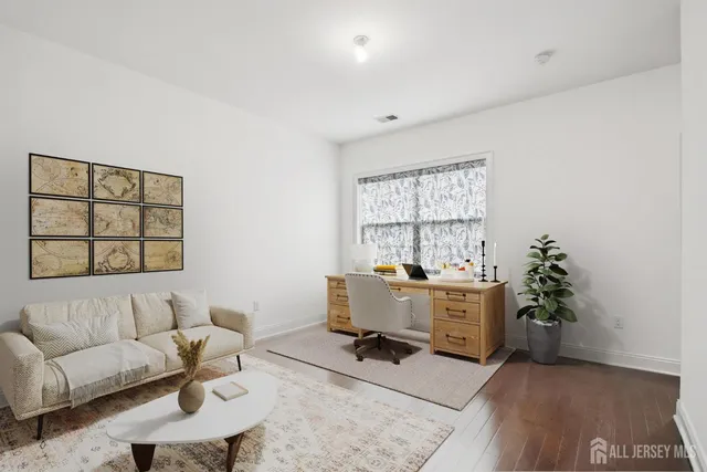 a view of a livingroom with workspace and a couch