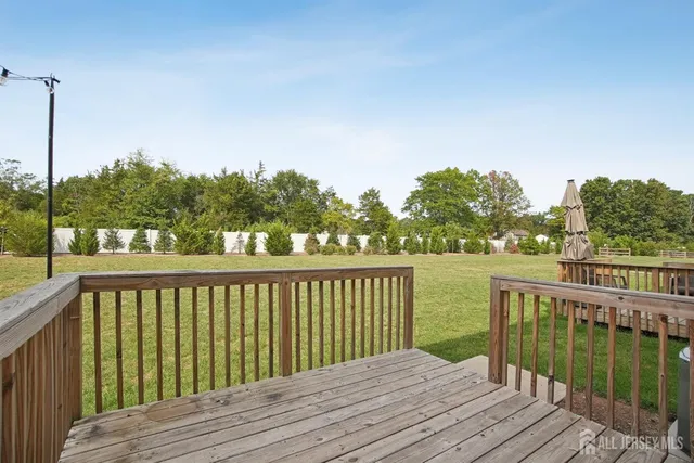 a balcony with wooden floor and fence