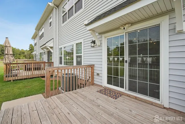 a view of a house with a wooden deck