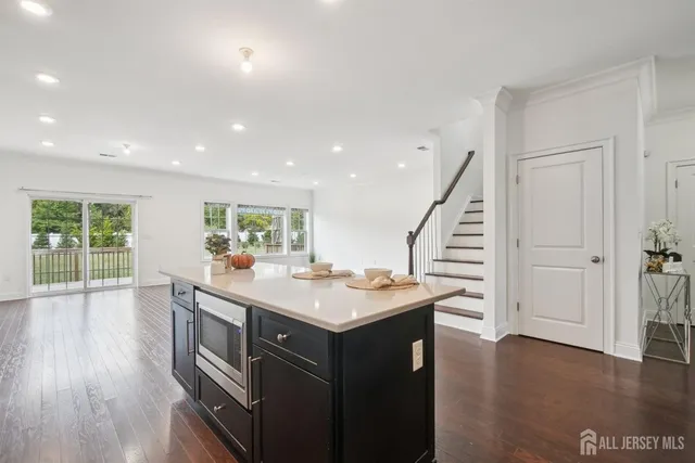 a kitchen with a sink and wooden floor