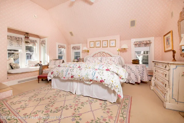 a spacious bathroom with a shower a sink and a mirror