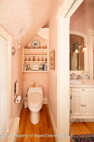 a bathroom with a shower sink and toilet