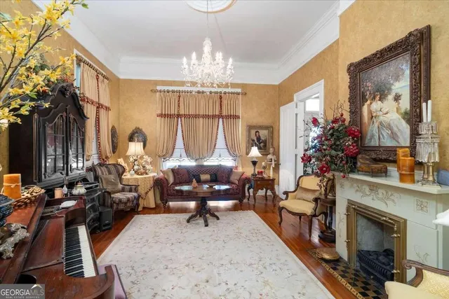 a view of a dining room with furniture and chandelier