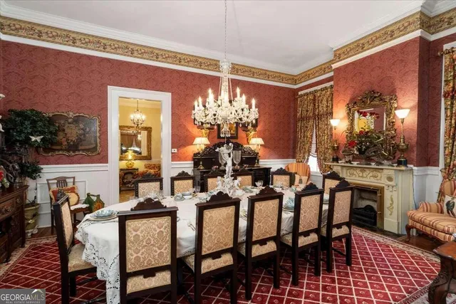 a view of a dining room with furniture and chandelier