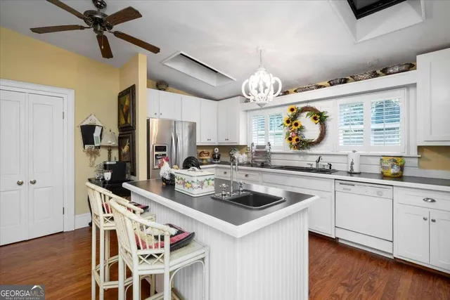 a kitchen with stainless steel appliances granite countertop a stove a sink and a refrigerator
