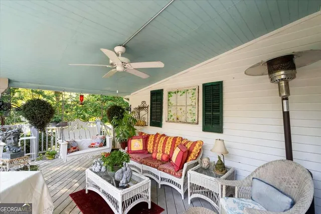a view of a house with a small yard and a large tree