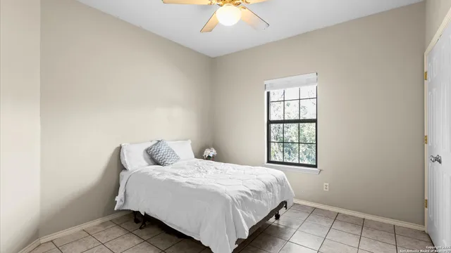 a bedroom with a bed and a window