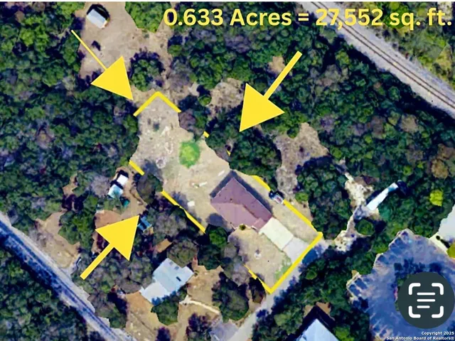 an aerial view of house with a yard and swimming pool