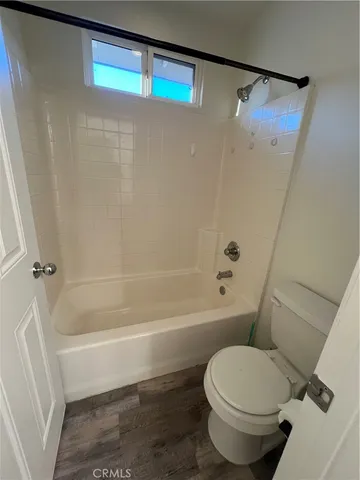 a view of a room with wooden floor and window