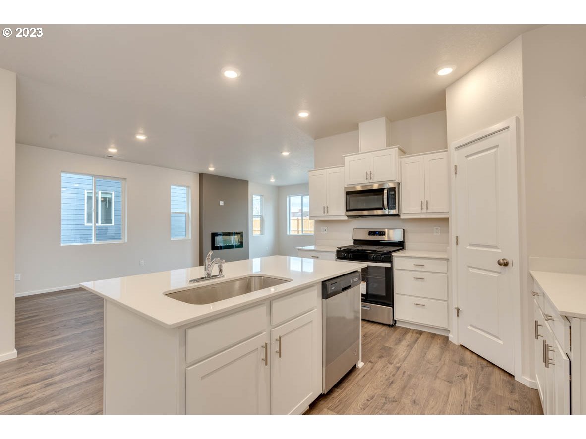 2675 Fenya Street Springfield, OR 97477 - Photo 10 of 20 a kitchen with a sink stainless steel appliances and white cabinets