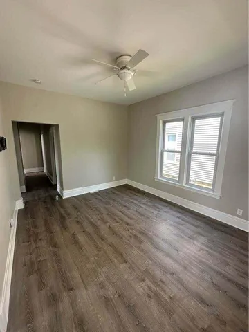 wooden floor in an empty room with a window