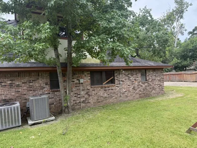 a backyard of a house with table and chairs