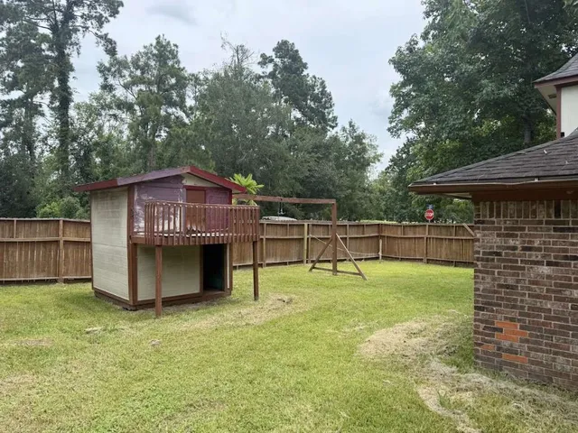 a view of a house with a backyard and a patio