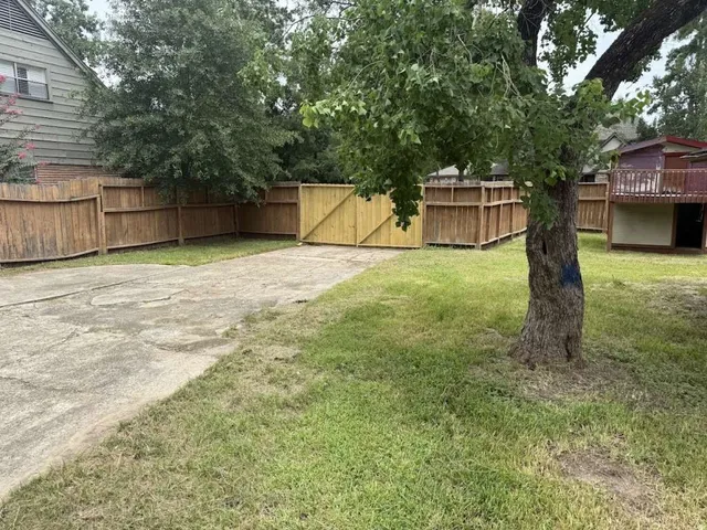 a backyard of a house with a swing and slide