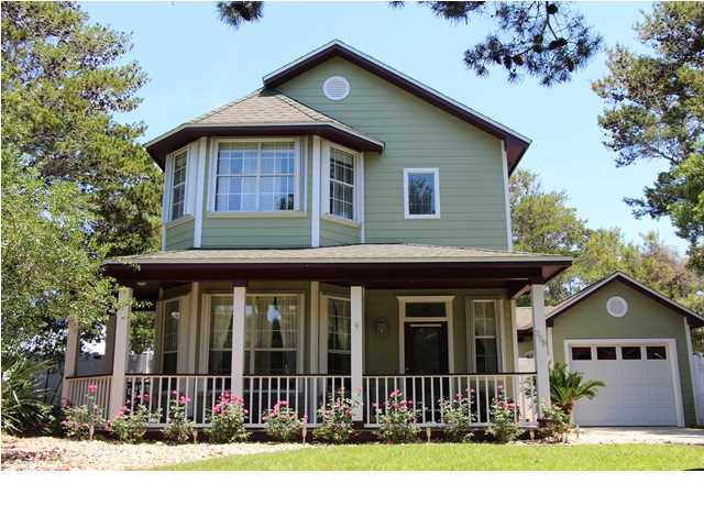 258 Seabreeze Circle Seacrest, FL 32461 - Photo 2 of 31 a front view of a house with a garden
