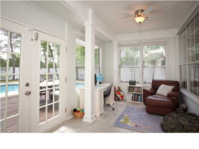 258 Seabreeze Circle Seacrest, FL 32461 - Photo 22 of 31 a living room with furniture a chandelier and a large window