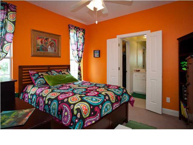 258 Seabreeze Circle Seacrest, FL 32461 - Photo 26 of 31 a bedroom with a bed and a chandelier