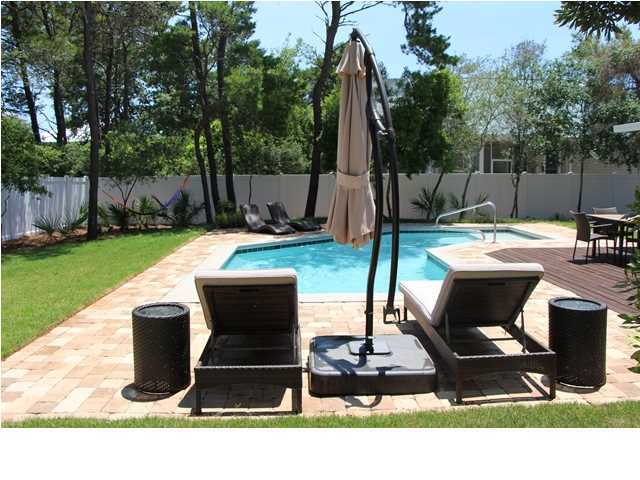 258 Seabreeze Circle Seacrest, FL 32461 - Photo 4 of 31 a view of backyard with seating space and trees