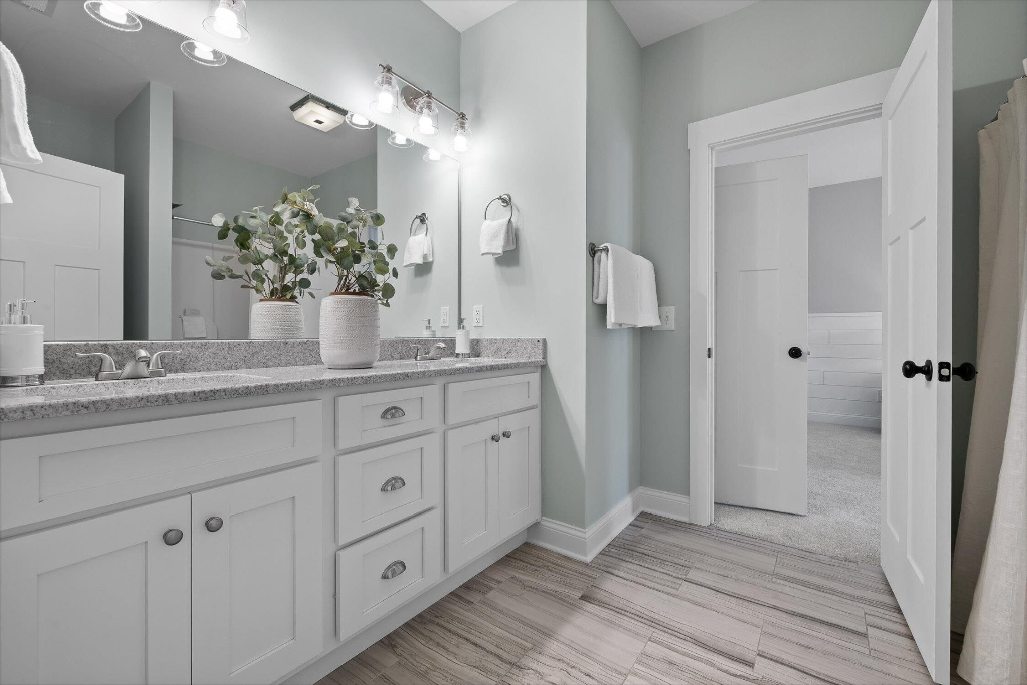 718 Windrush Loop Chattanooga, TN 37421 - Photo 19 of 29 a bathroom with a granite countertop sink a mirror and a shower