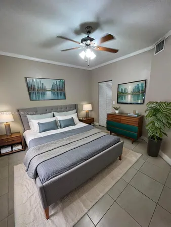 a bedroom with bed and a chandelier