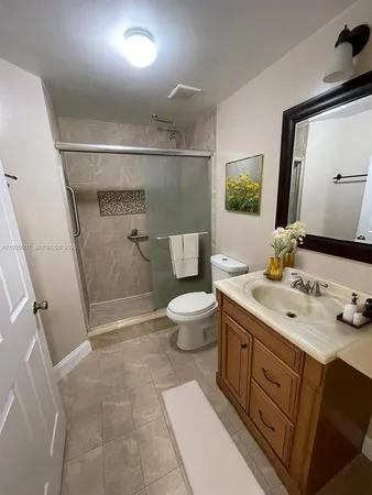 a spacious bathroom with a sink a toilet and a mirror