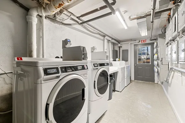 a view of a storage & utility room with dryer and washer
