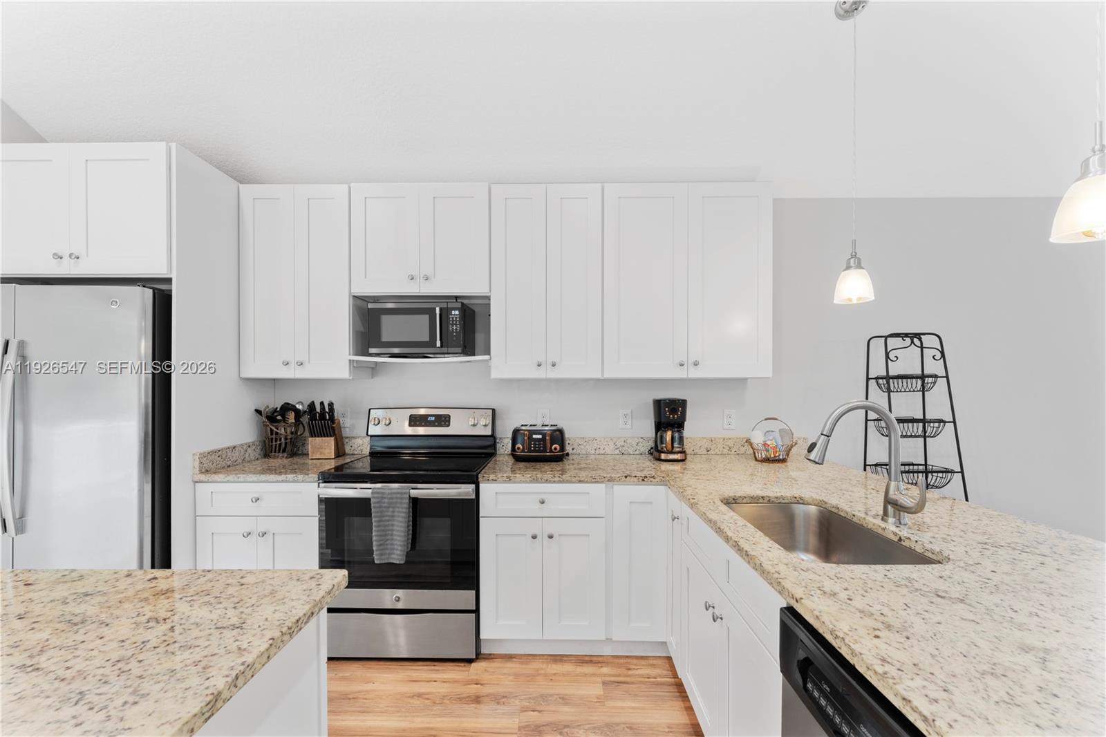 2 Poinciana Cove Road St. Augustine, FL 32084 - Photo 20 of 43 a kitchen with granite countertop a sink a stove and refrigerator