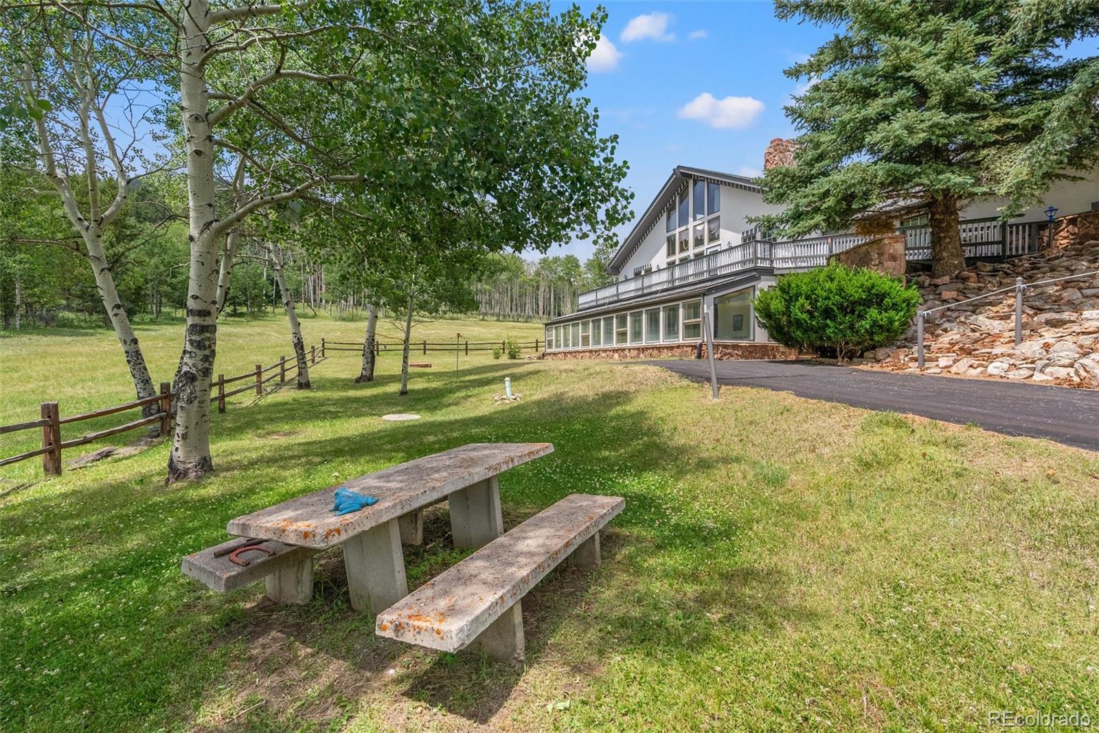 front view of a house with a yard table and chairs