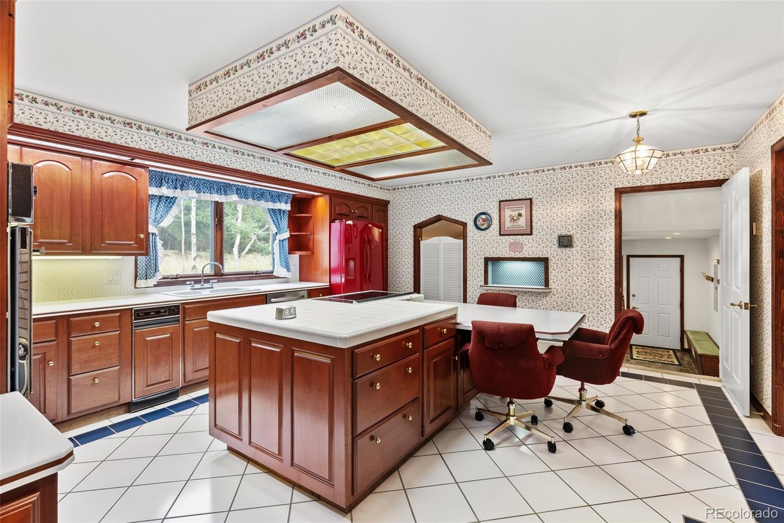 1680 Crow Valley Road Bailey, CO 80421 - Photo 13 of 50 a kitchen with a stove top oven cabinets a sink and a window