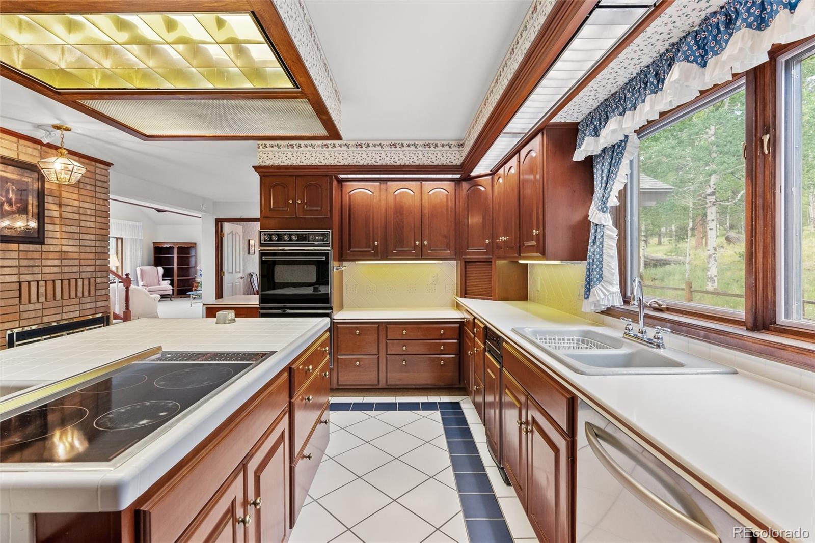 1680 Crow Valley Road Bailey, CO 80421 - Photo 14 of 50 a kitchen with a stove a sink and a refrigerator