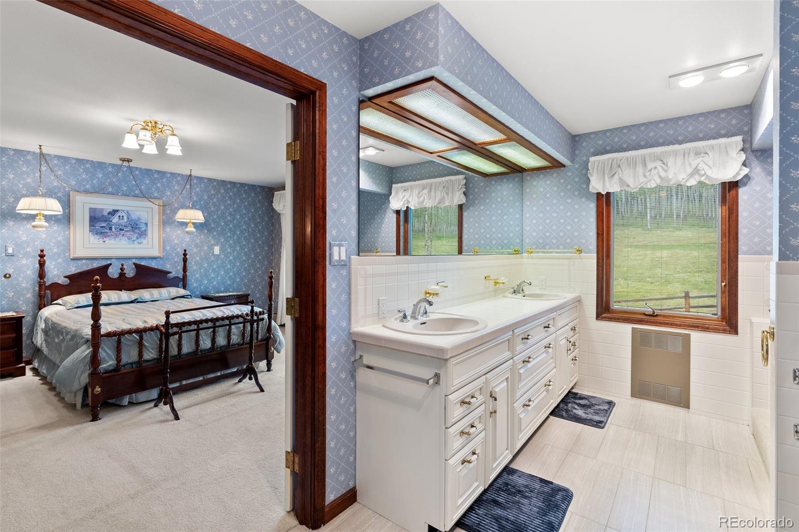 1680 Crow Valley Road Bailey, CO 80421 - Photo 17 of 50 a spacious bedroom with a bed and a dresser