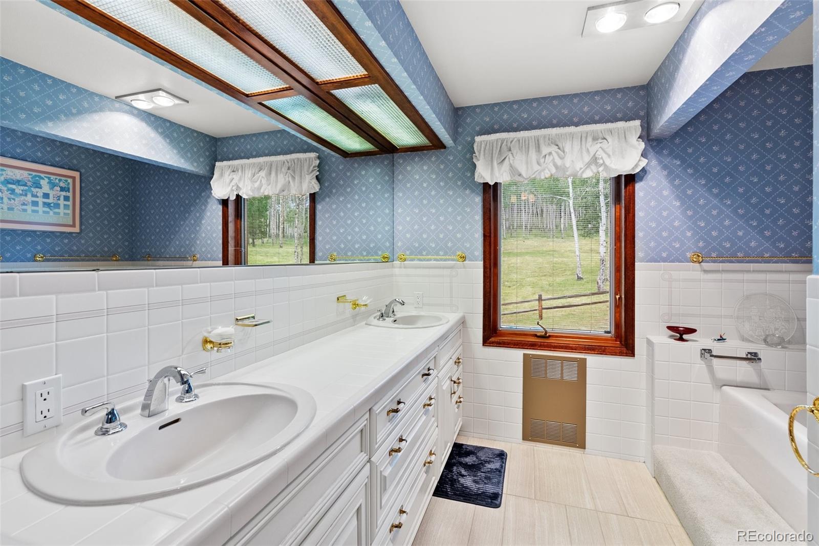 1680 Crow Valley Road Bailey, CO 80421 - Photo 18 of 50 a bathroom with a sink and a mirror