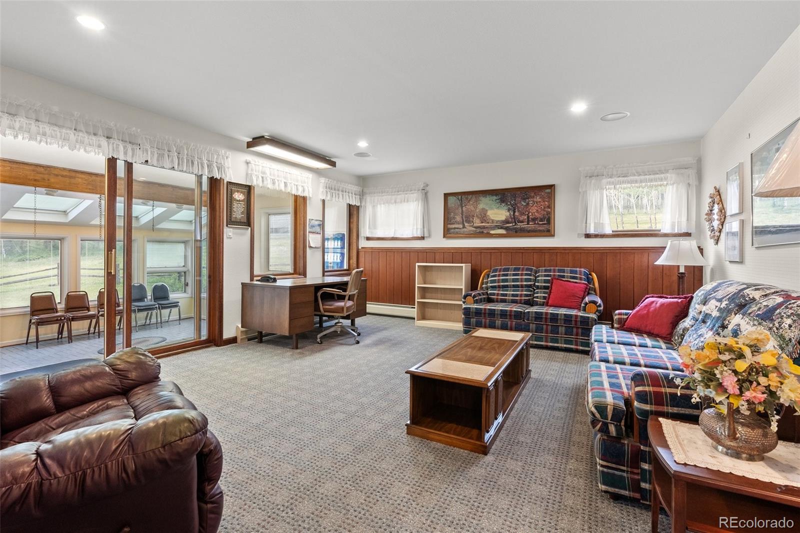 1680 Crow Valley Road Bailey, CO 80421 - Photo 25 of 50 a living room with furniture and a flat screen tv