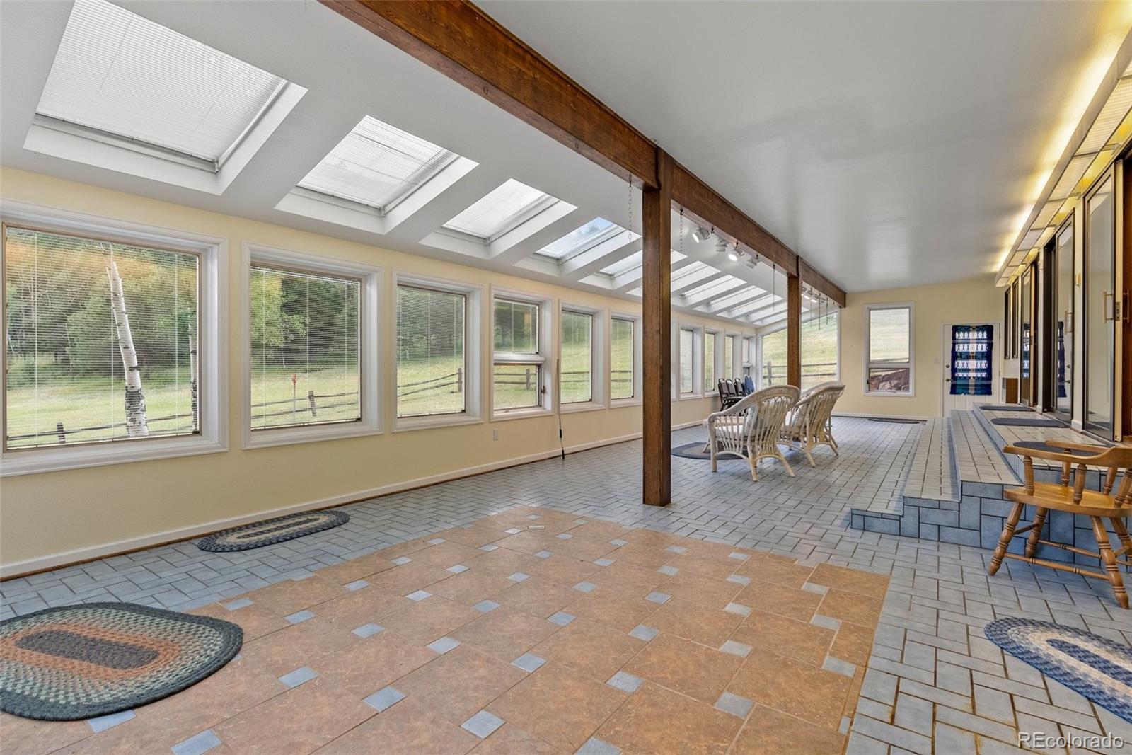 1680 Crow Valley Road Bailey, CO 80421 - Photo 27 of 50 a living room filled with furniture window and dining table