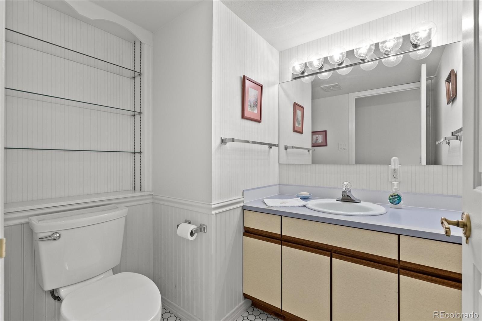 1680 Crow Valley Road Bailey, CO 80421 - Photo 28 of 50 a bathroom with a toilet sink and mirror