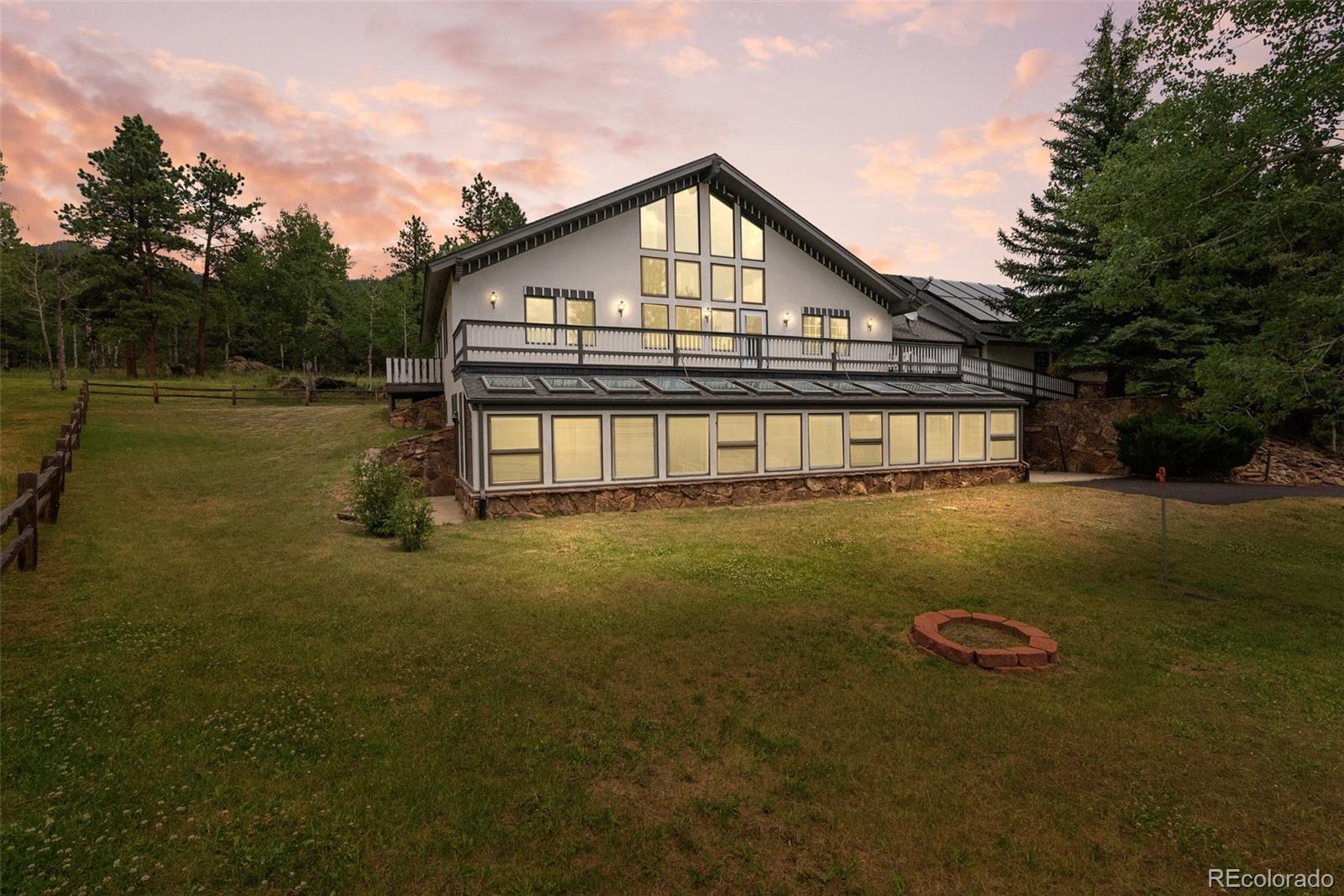 1680 Crow Valley Road Bailey, CO 80421 - Photo 3 of 50 a front view of a house with a yard