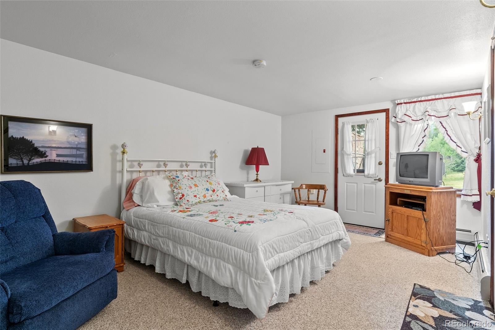 1680 Crow Valley Road Bailey, CO 80421 - Photo 31 of 50 a bedroom with a bed couch and a window