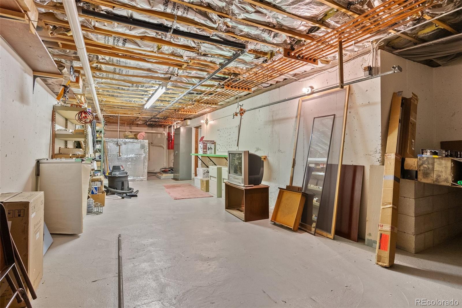 1680 Crow Valley Road Bailey, CO 80421 - Photo 36 of 50 a view of a storage room with a fridge and windows