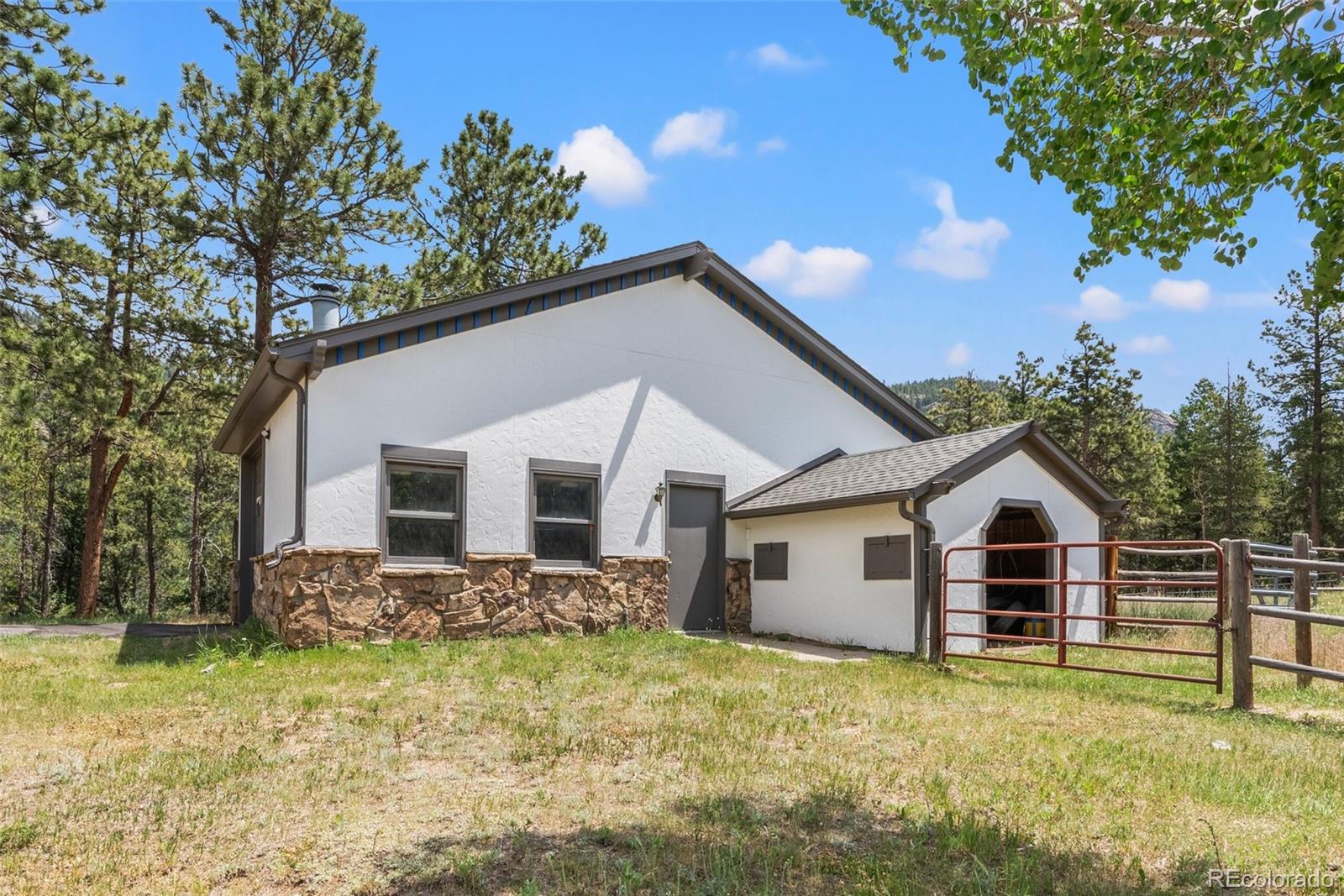 1680 Crow Valley Road Bailey, CO 80421 - Photo 39 of 50 a front view of a house with garden