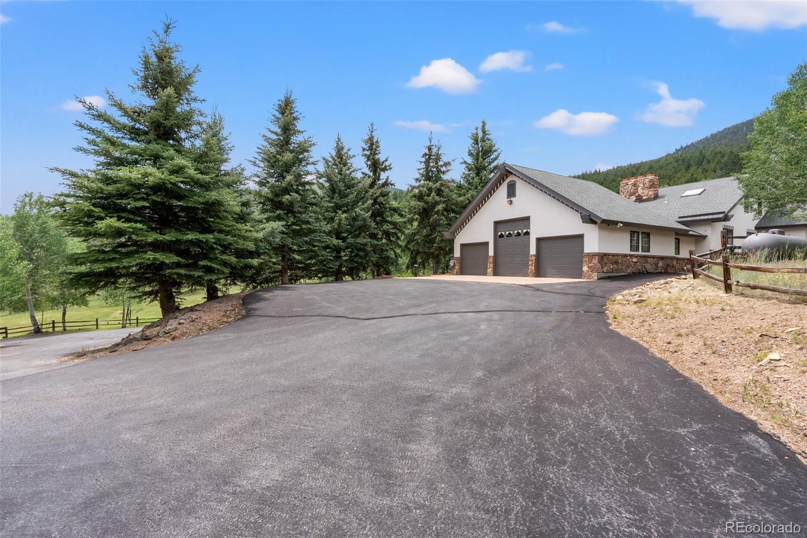 1680 Crow Valley Road Bailey, CO 80421 - Photo 4 of 50 a view of a house with a backyard and road