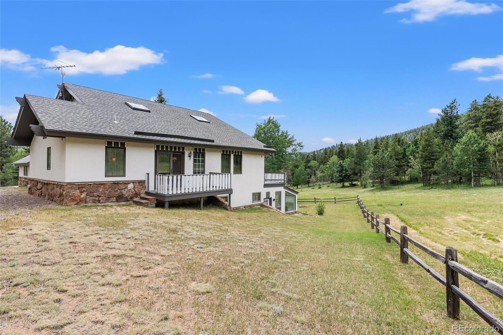 1680 Crow Valley Road Bailey, CO 80421 - Photo 43 of 50 a view of a house with backyard patio and garden