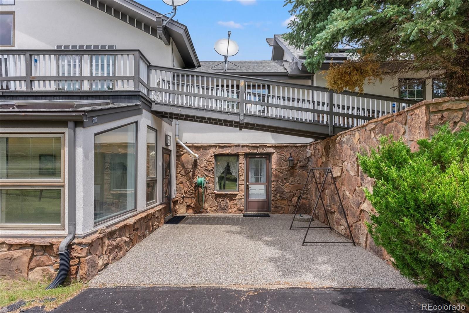 1680 Crow Valley Road Bailey, CO 80421 - Photo 7 of 50 a view of a house with porch and furniture